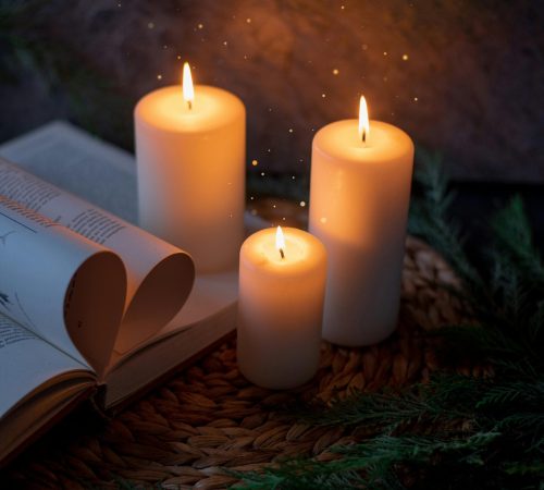 Warm and inviting candlelit setting with an open book, perfect for relaxation.