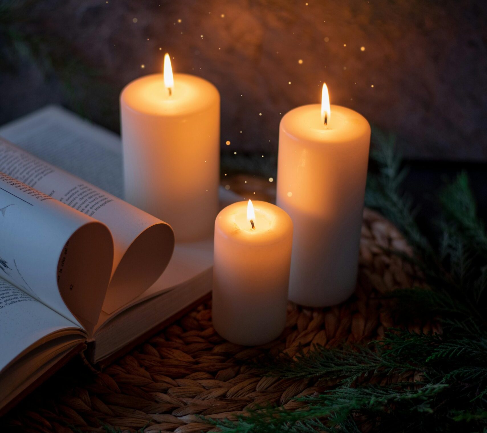 Warm and inviting candlelit setting with an open book, perfect for relaxation.